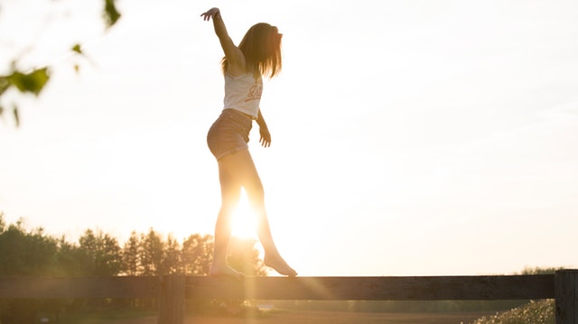 woman-walking-on-fence-1548769.jpg